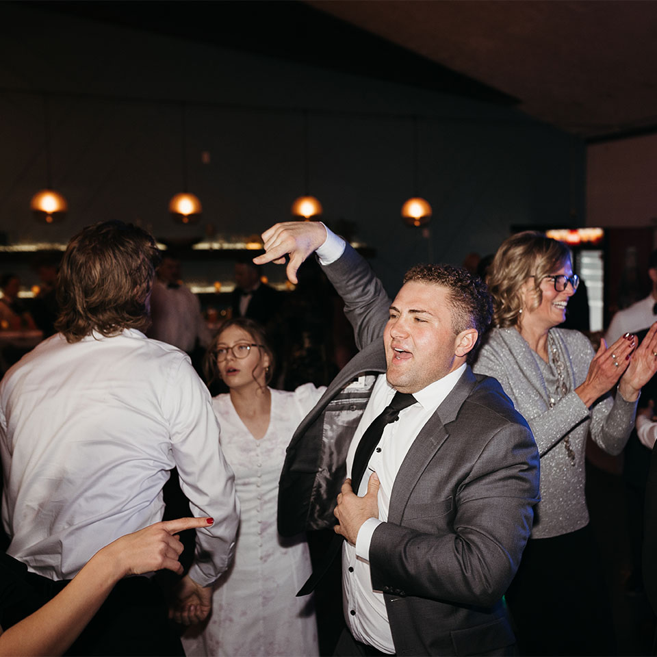 Young man in suit dancing on the dance floor